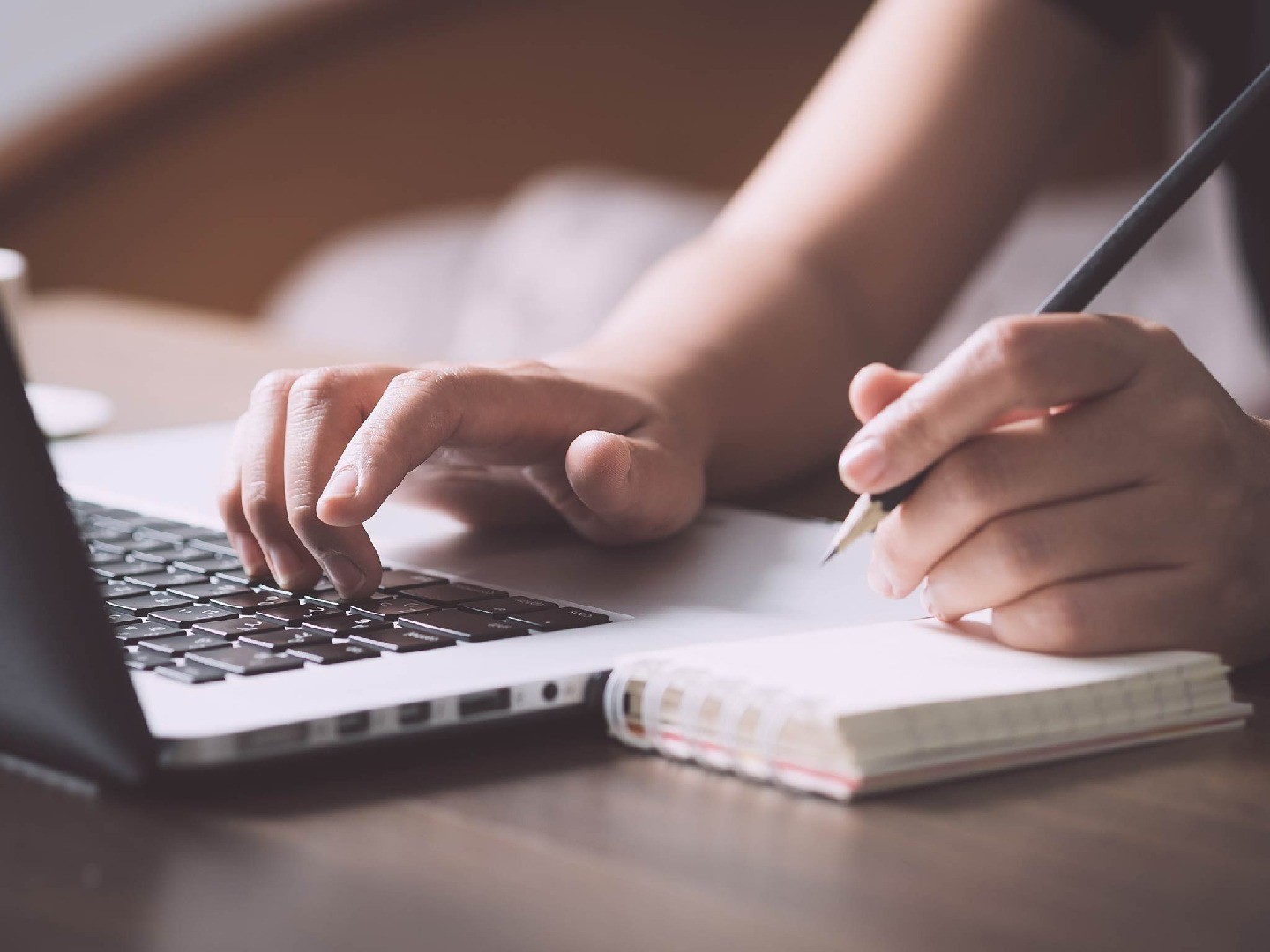 Someone typing on a laptop