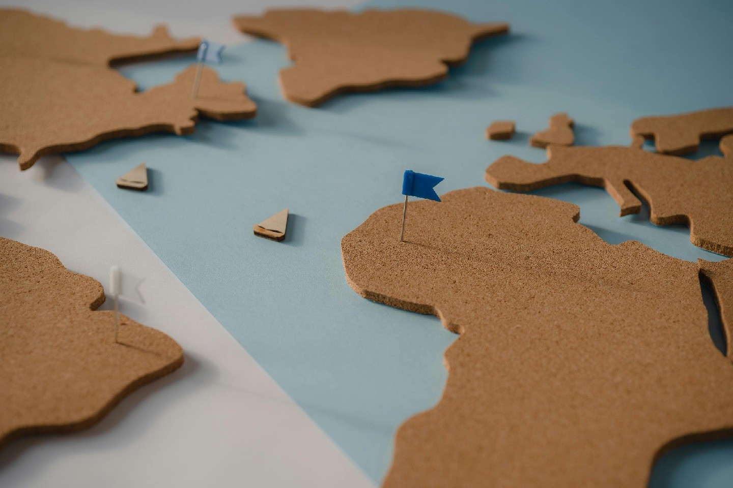 Map of the world composed of cork with a flag pin in Africa