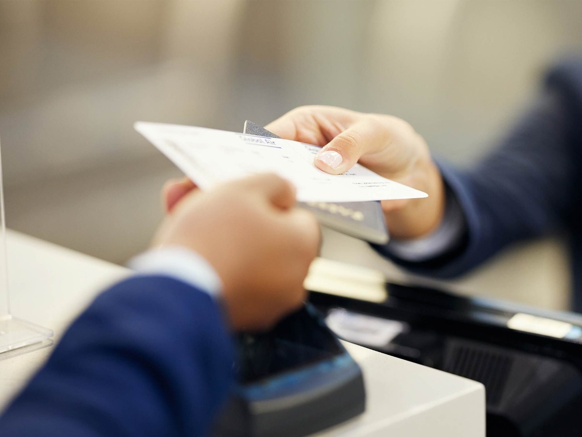 Two hands exchanging documents
