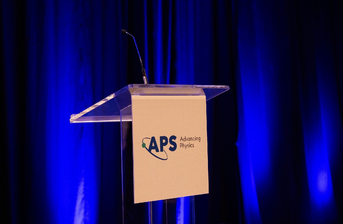 The APS logo on a podium at the 2025 Annual Leadership Meeting
