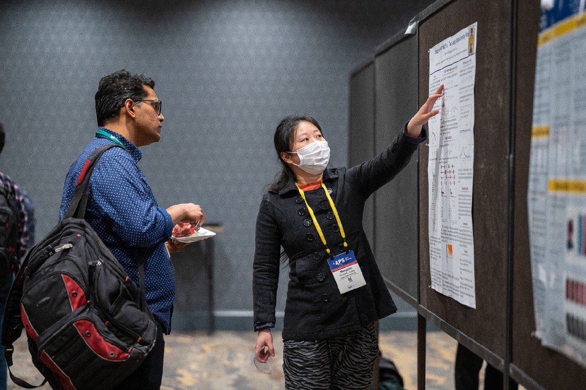 A woman presenting a scientific poster