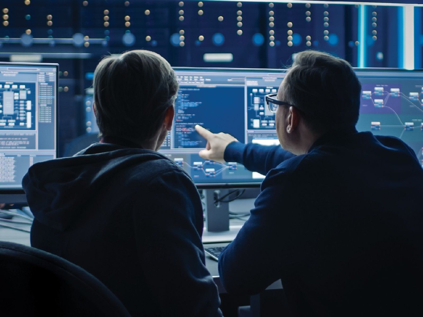 A professor and a student looking at computer screens