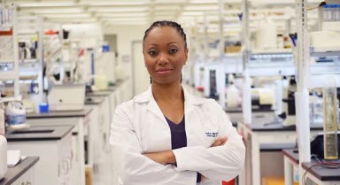 A Black woman working in a lab