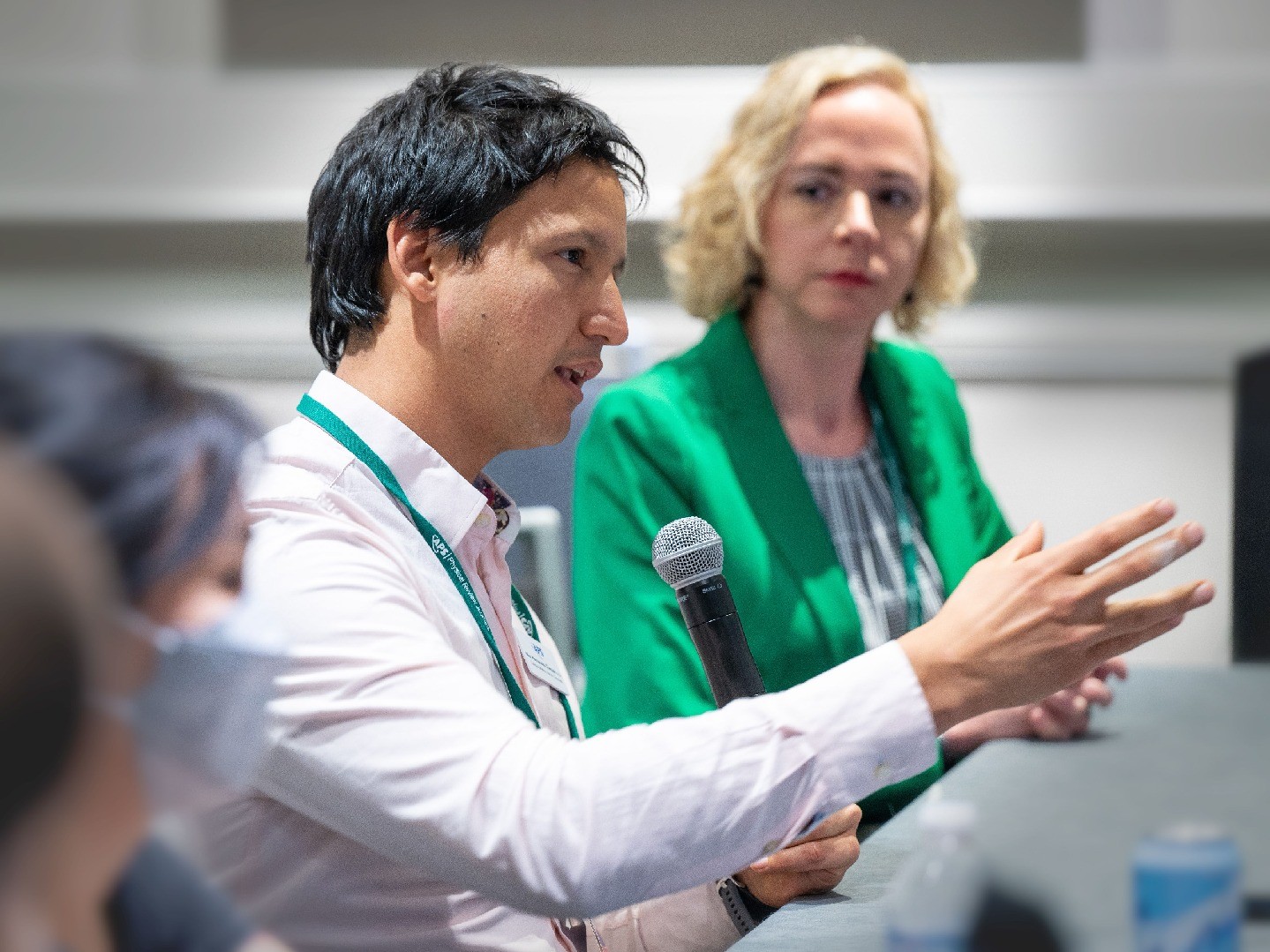 A person with a microphone speaking at an APS meeting