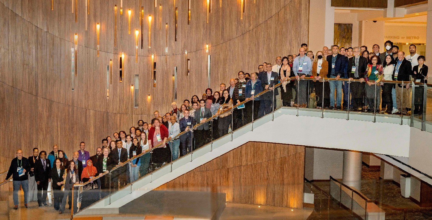 Group of science advocates stand on stairs posing for photo. 