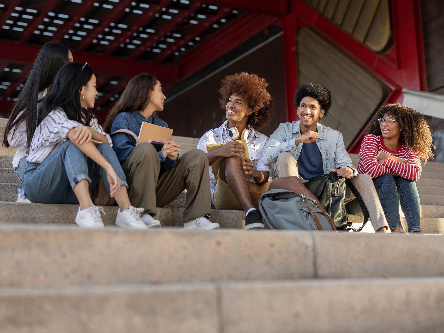 A group of students chatting together on steps