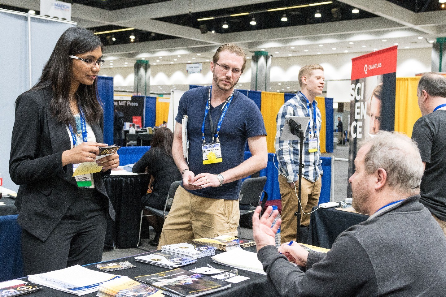 Students speaking with a exhibitor at March Meeting