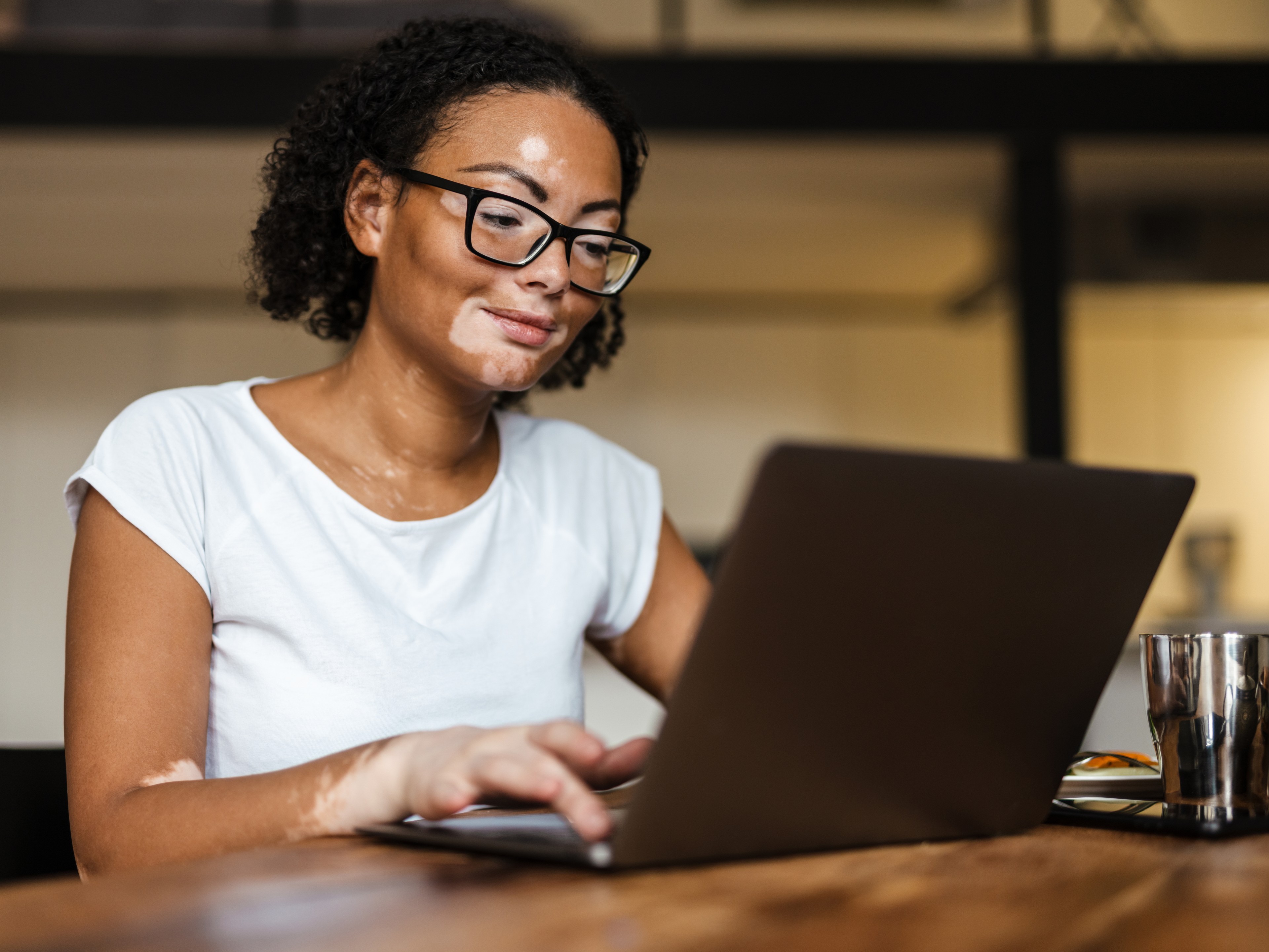 A woman working at a laptop computer