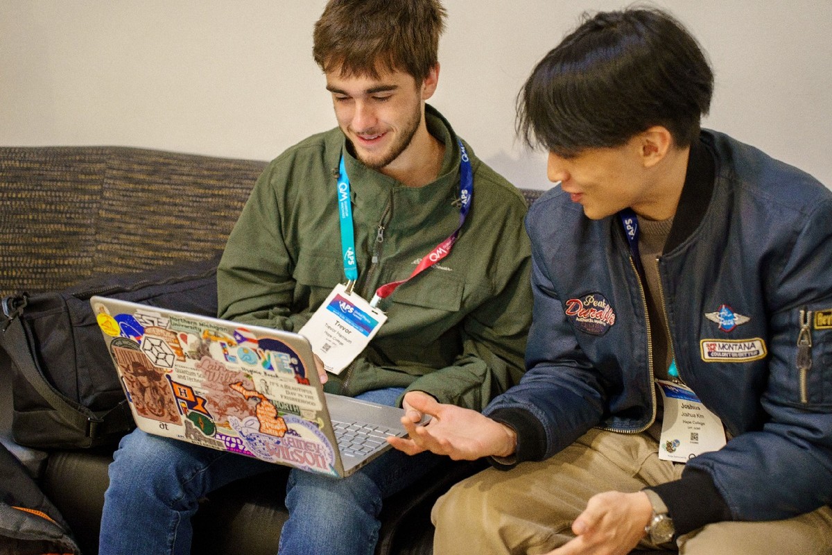 Students looking at a laptop together