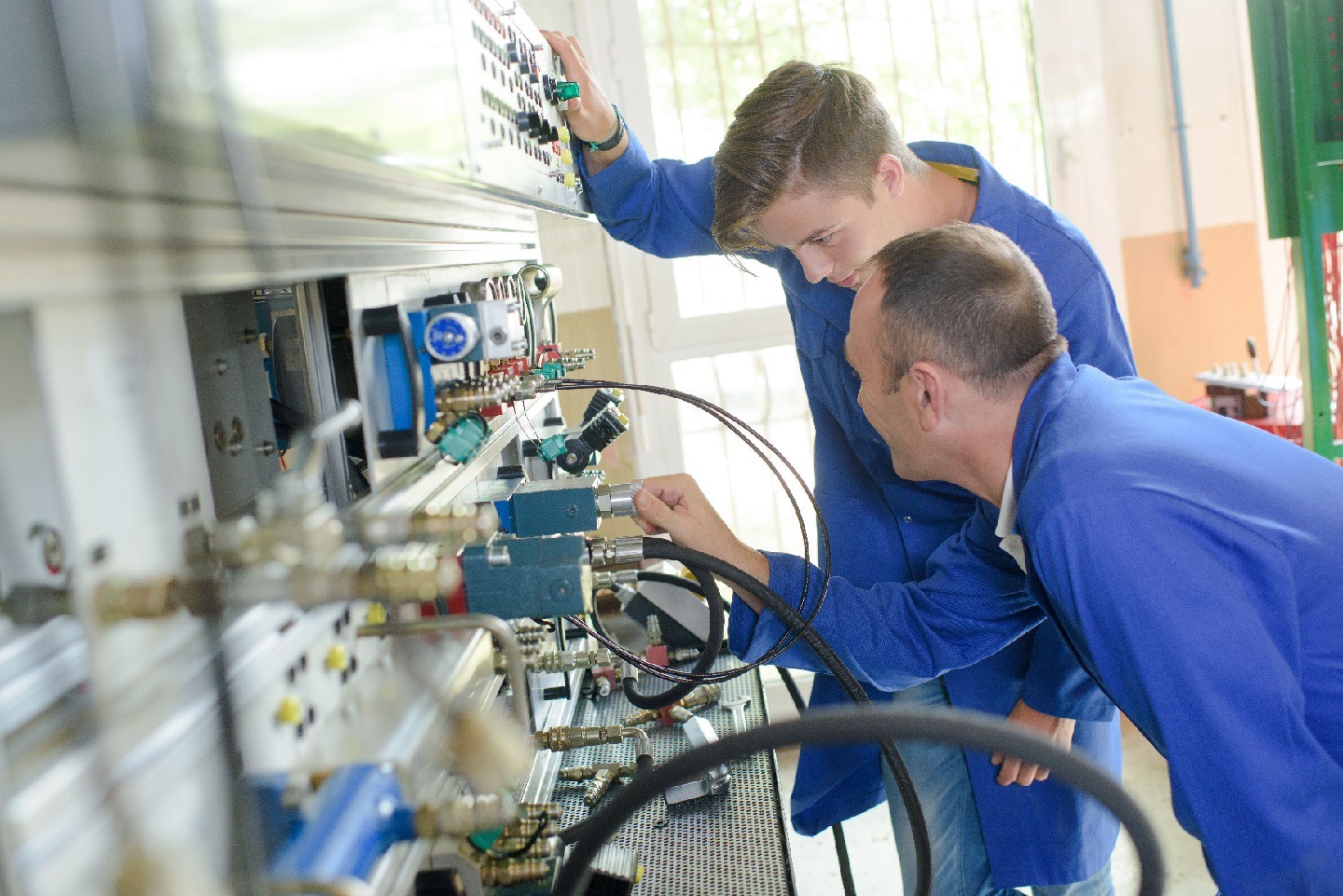 A student and a mentor looking at lab equipment