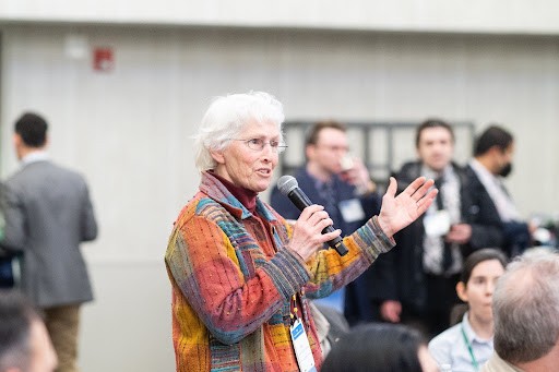 Beverly Karplus Hartline speaking into a microphone.
