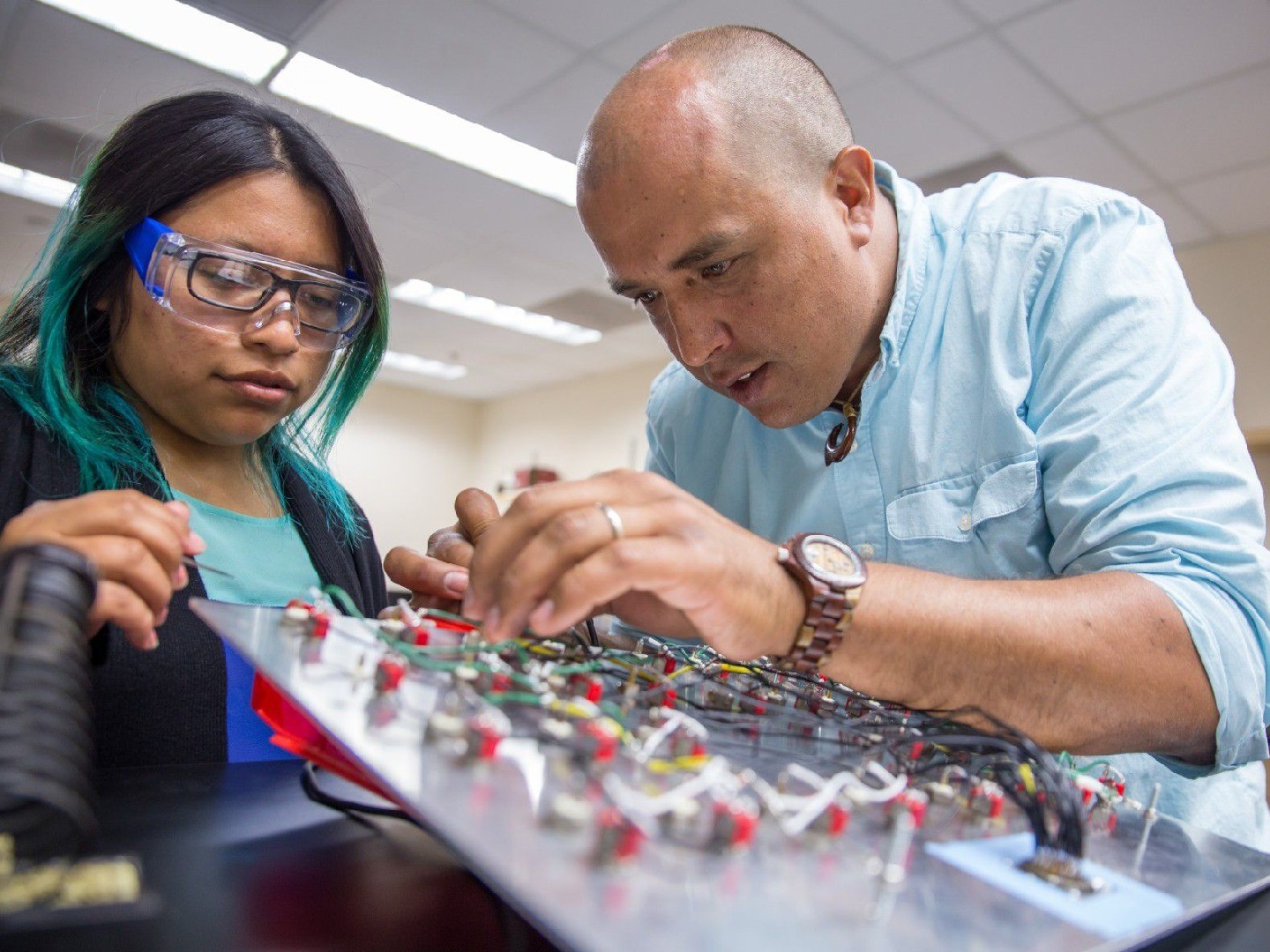 An instructor attempts to fix a problem brought by his student.