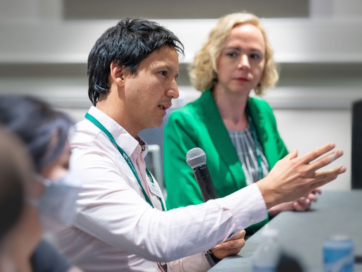 A person with a microphone speaking at an APS meeting