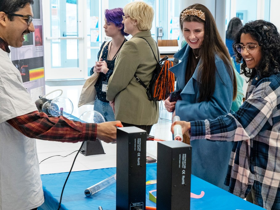Students at a vendor booth at a scientific conference