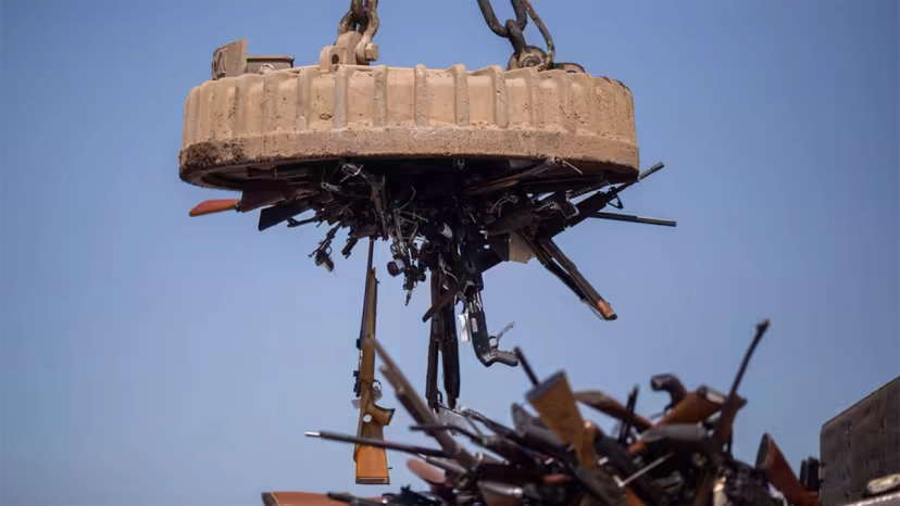 An electromagnet is used to pick up some of the approximately 3,500 confiscated guns to be melted down.