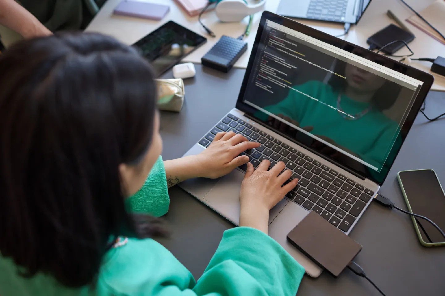 A young woman works at a laptop