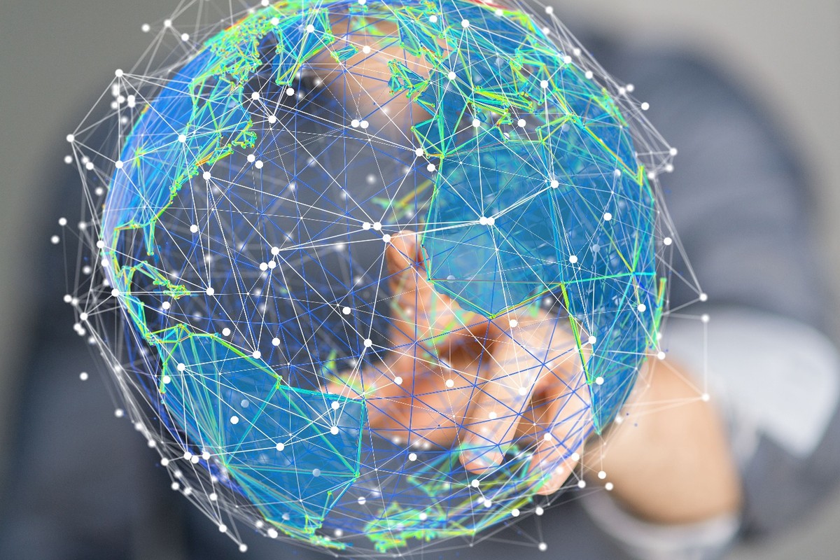 A hand touching a globe
