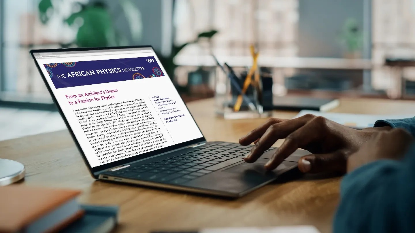A person reading the African Physics Newsletter on a laptop