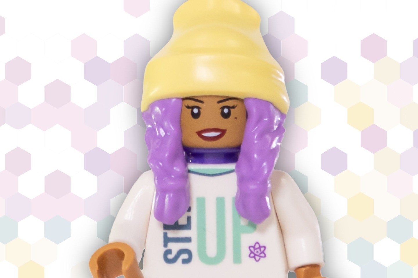 A female Lego minifig against a pattern of hexagons