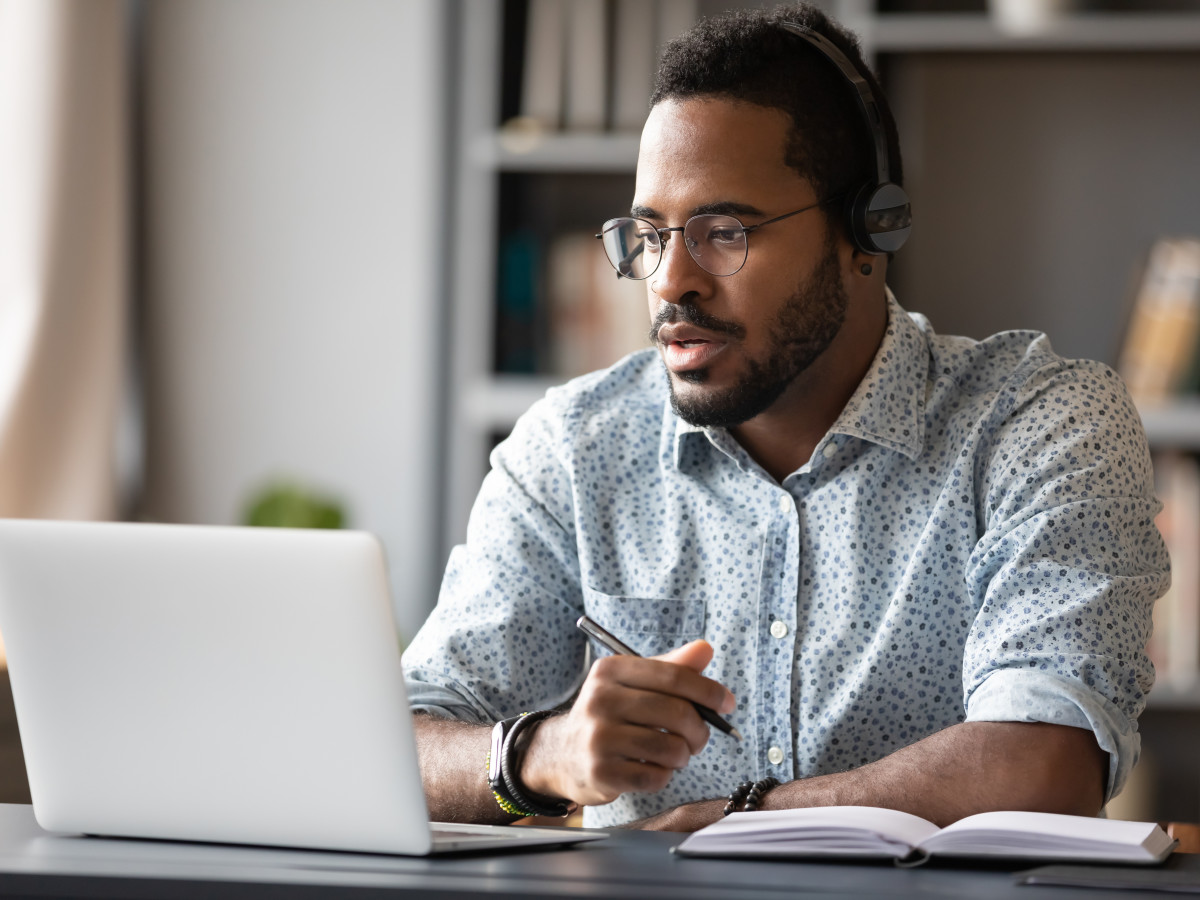 Man participates in a webinar on his laptop