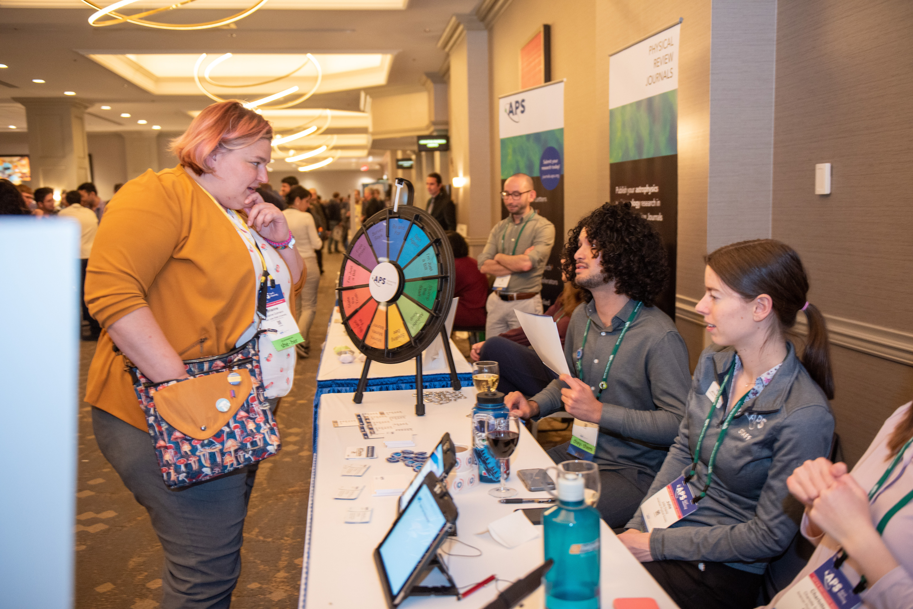APS staff speaking with an attendee at April Meeting 2023