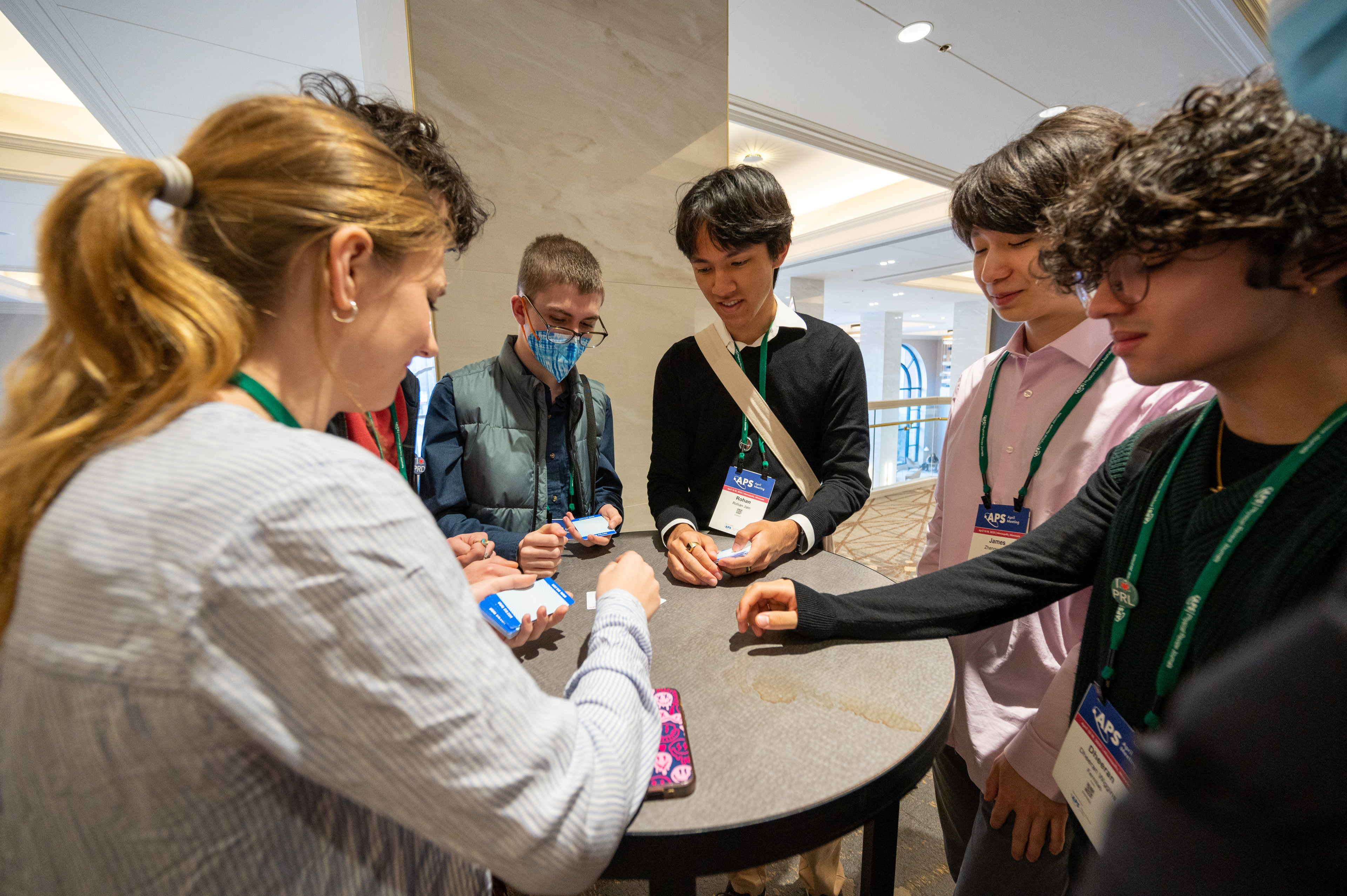 A group of students standing around a table