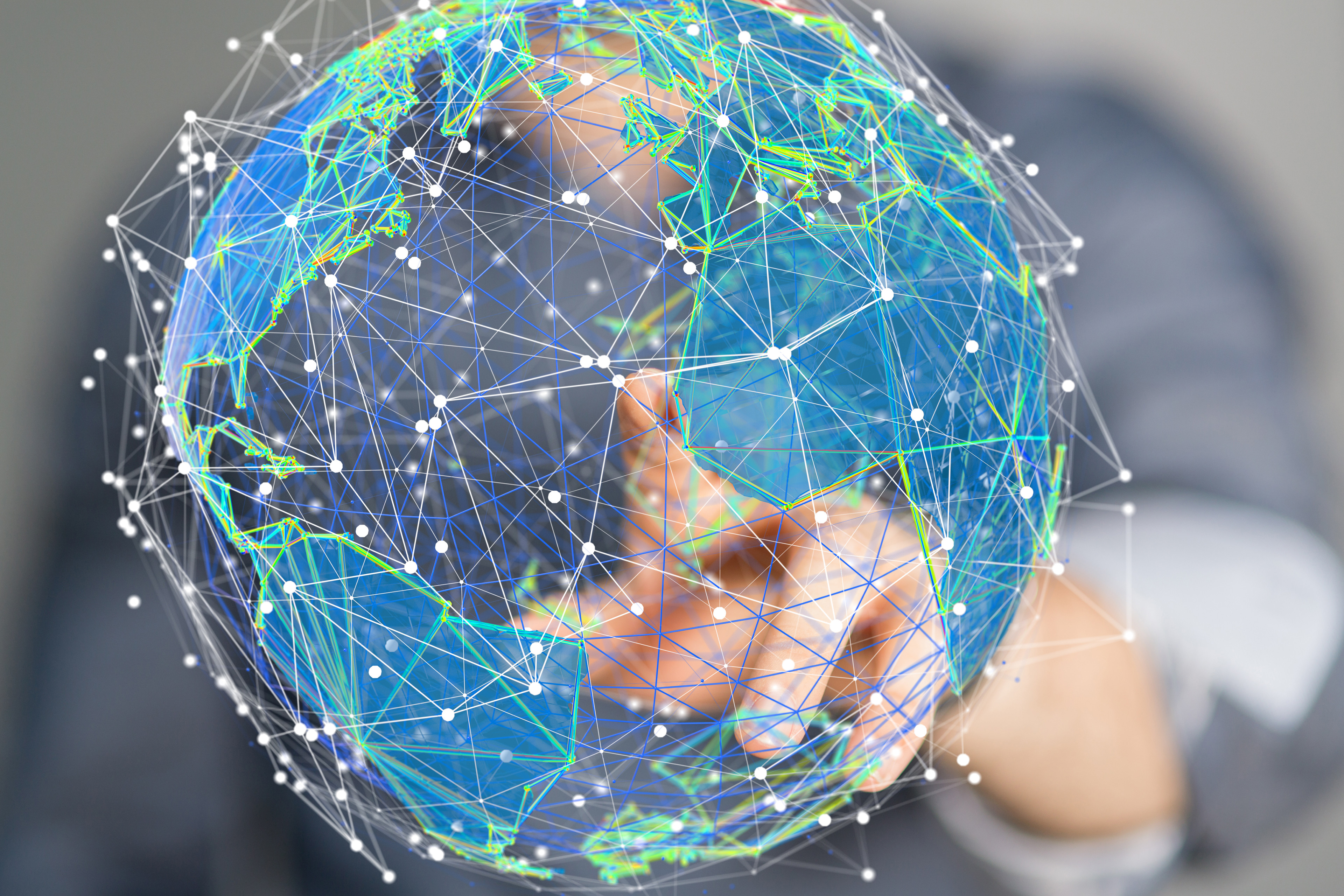 A person points to a global instructional sphere